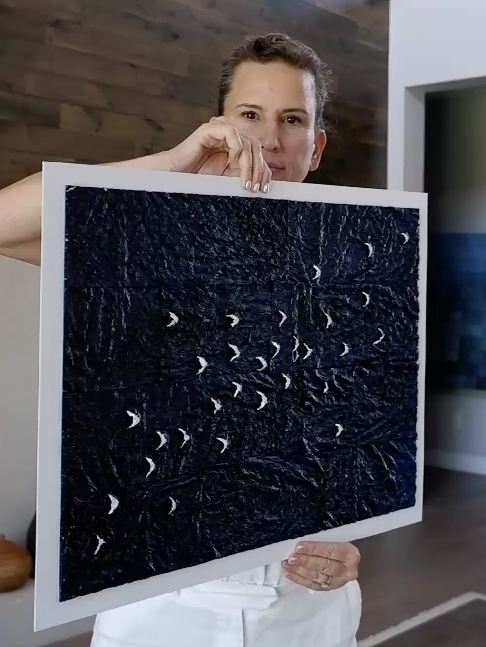 Laura holding up Midnight Passage painting, and rotating it so it shows the moonlight appearing and disappearing.